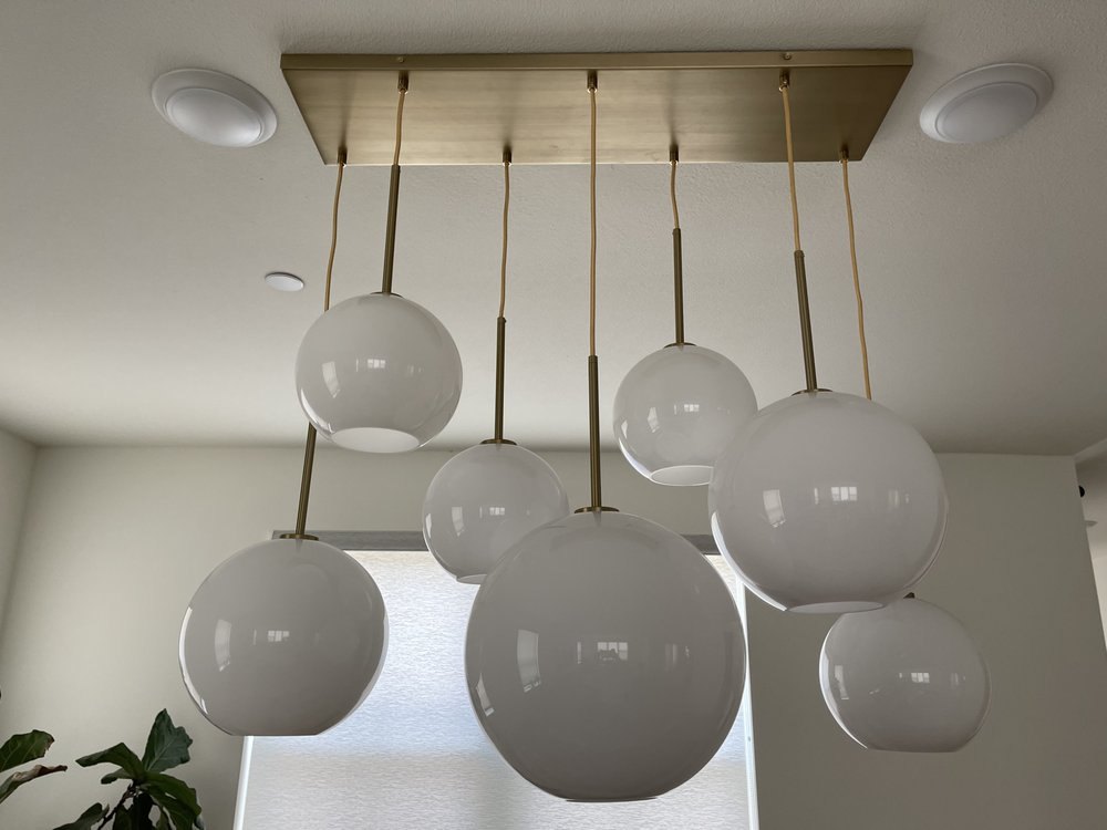 Seven-globe cluster pendant on a brass canopy with recessed lights