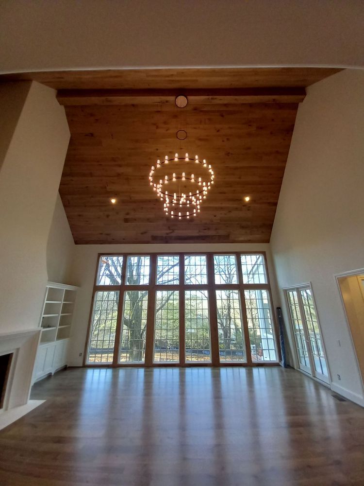 Two-tier ring chandelier on a vaulted wood ceiling