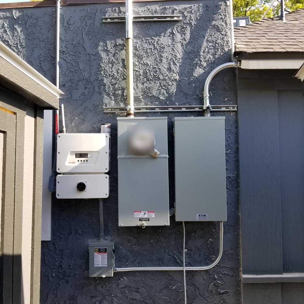 New meter main and panel beside a solar inverter and disconnect